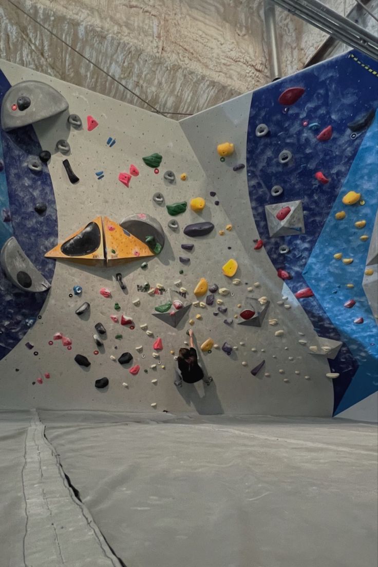 an indoor climbing gym with rock climbing walls