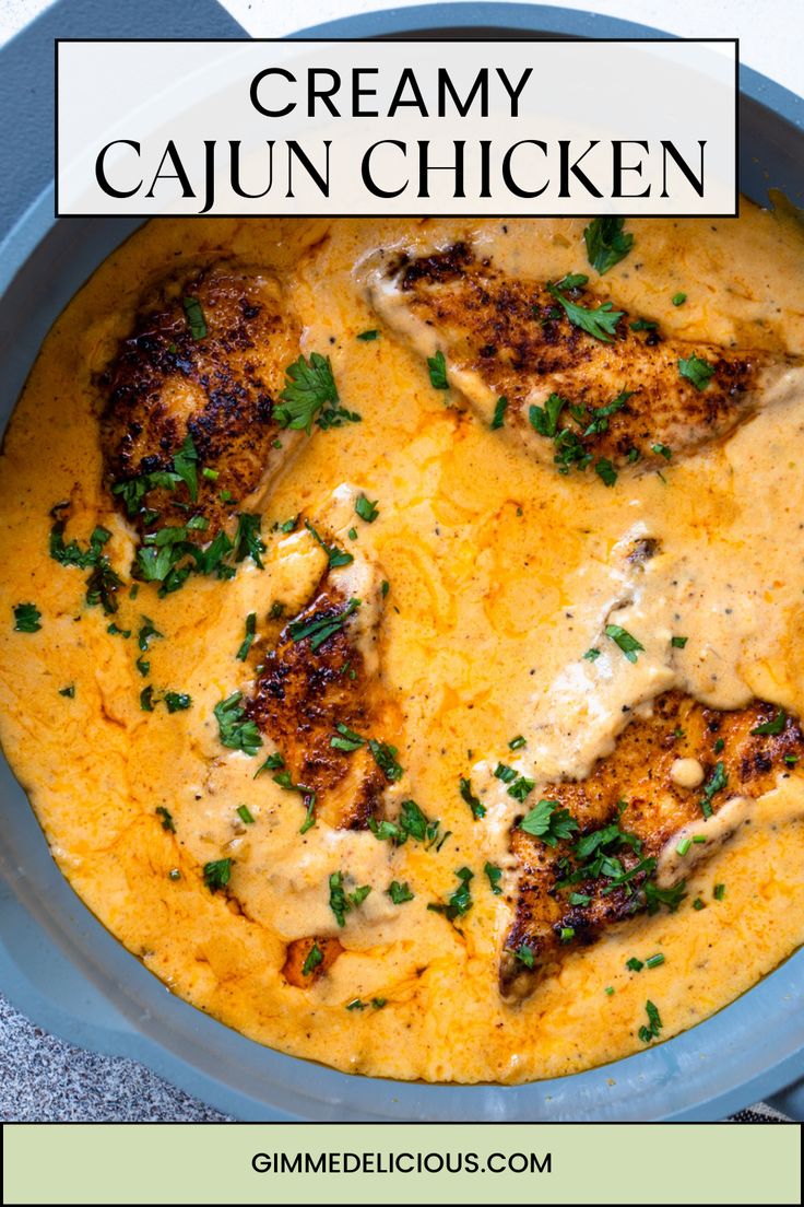 creamy cajun chicken in a blue bowl with garnishes and parsley