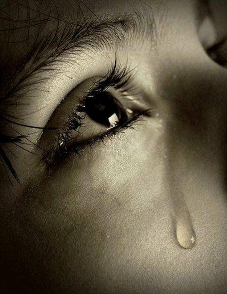 a woman's eye with tears on it