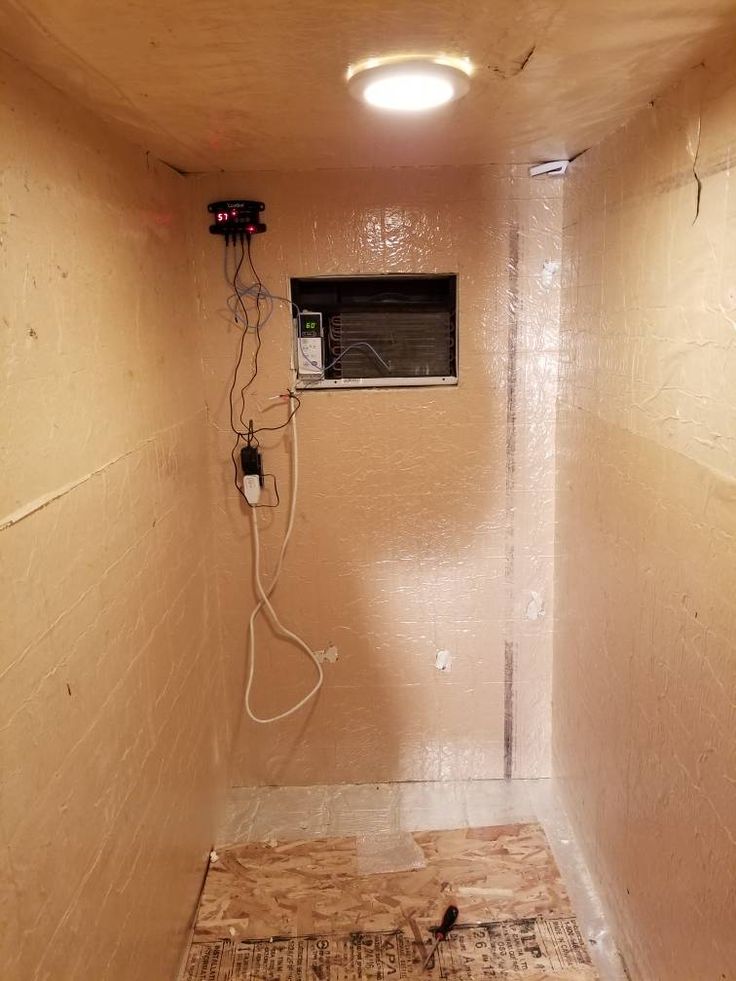 an unfinished room with a heater and air conditioner