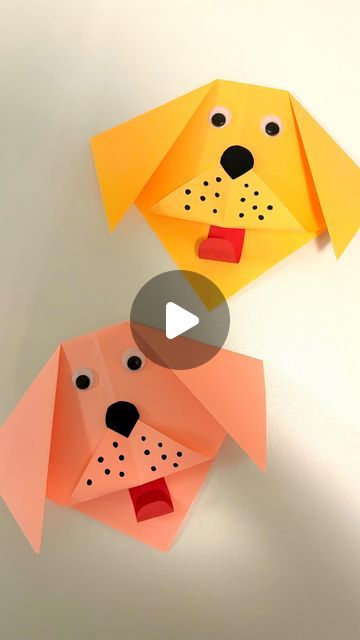 two origami dogs with faces on them