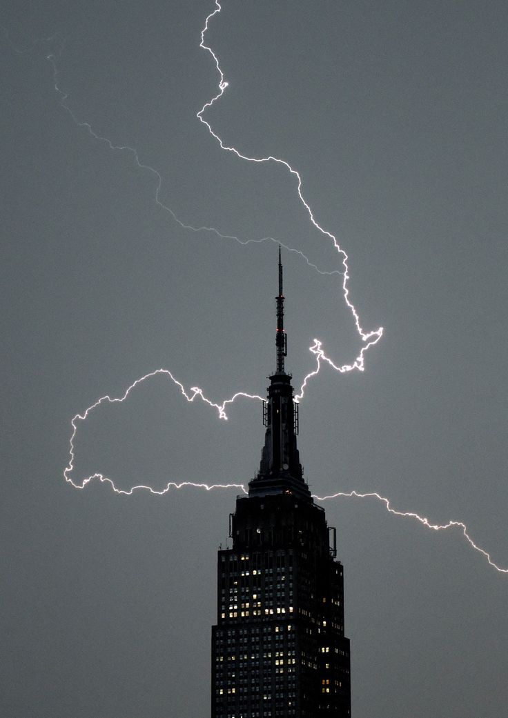 lightning strikes over the empire building in new york city, ny on july 29, 2012