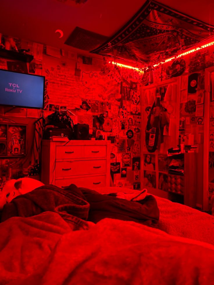 a bedroom with red lights and pictures on the wall