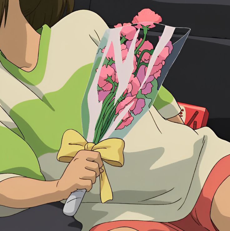 a woman sitting in the back seat of a car holding a bouquet of pink flowers