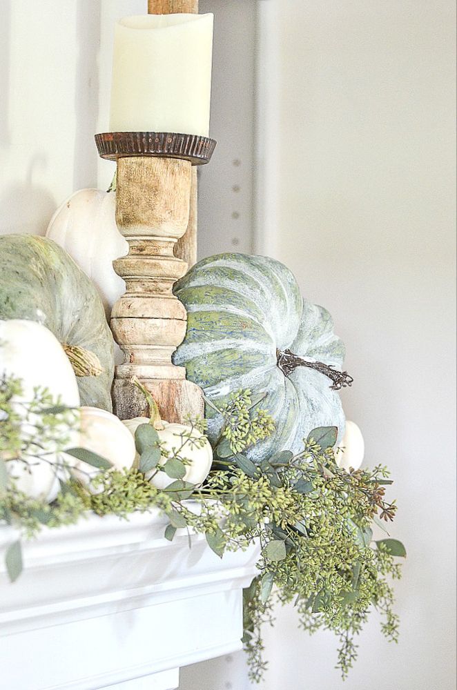 an easy fall mantel decoration with candles and gourds