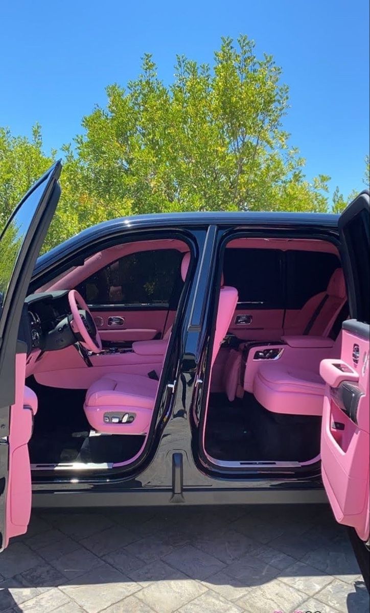 a pink car with its doors open and the door ajar is shown in this photo