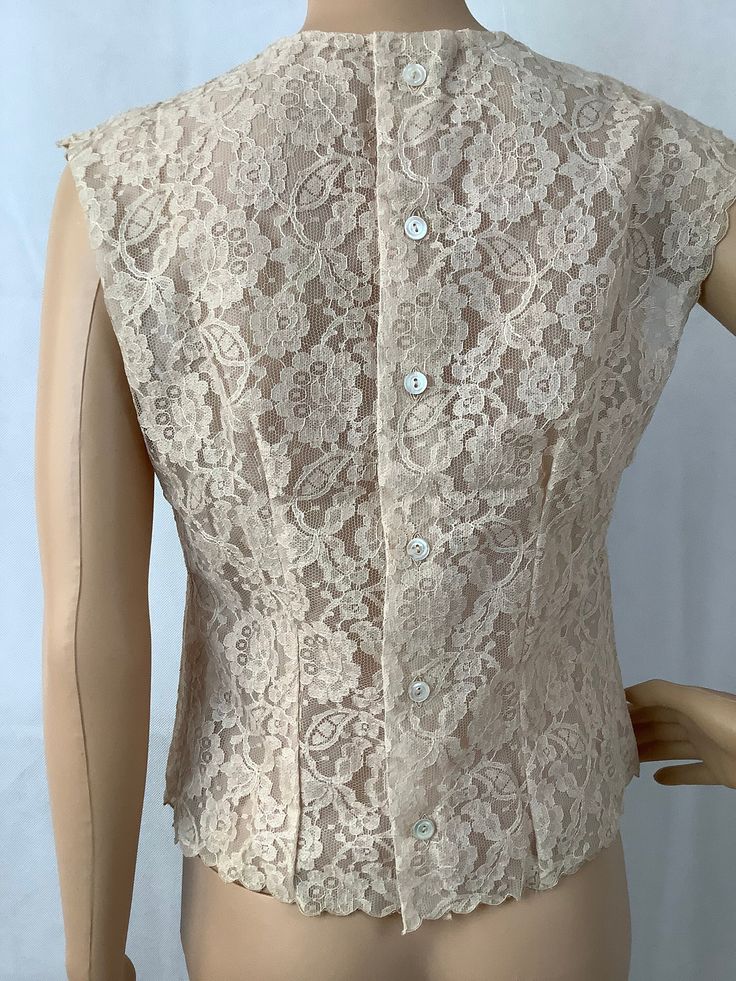 "Gorgeous antique lace blouse with button down back Tagged size 32, see measurements below Measurements are approximate and taken laying flat, double where appropriate 17\" bust armpit to armpit 17\" hip taken along hem 16\" waist Gorgeous floral lace in cream/beige, darting at bust and back accent the bodies shape. Top is lined in matching tone sheer fabric Scalloped edges at arms and hem, also beautiful cutouts highlight the neck Excellent vintage condition no issues found" Fitted Scalloped Lace Blouse, Formal Fitted Blouse With Scalloped Lace, Summer Fitted Blouse With Scalloped Lace, Elegant Fitted Blouse With Scalloped Lace, Fitted Scalloped Lace Sleeveless Top, Fitted Scalloped Lace Short Sleeve Top, Fitted Summer Tops With Scalloped Lace, Elegant Sleeveless Button Blouse, Classic Lace Tops With Lace Work