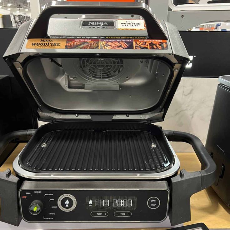 an open grill on top of a counter in a room with other items around it