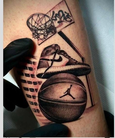 a tattoo on the leg of a man with basketballs and sneakers