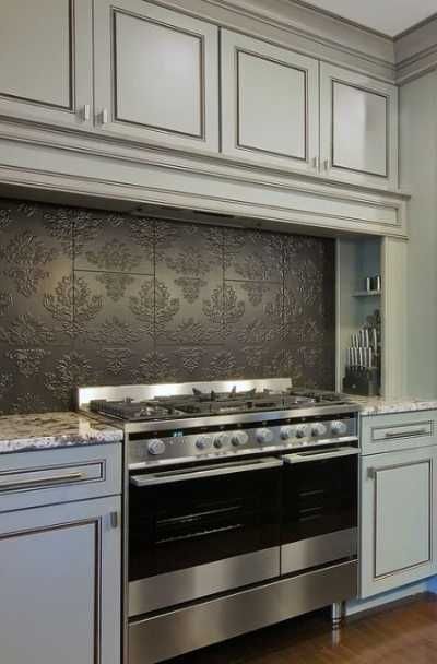 a kitchen with an oven, stove and cabinets in the middle of it's counter space