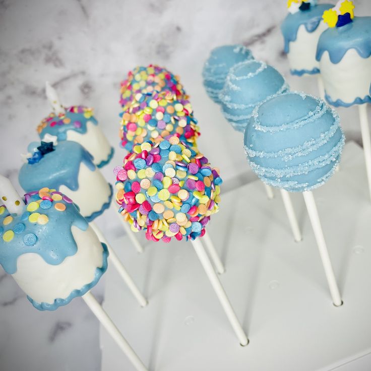 cake pops with blue frosting and sprinkles