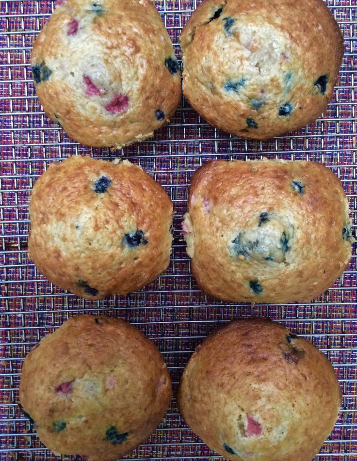 four blueberry muffins on a wire rack