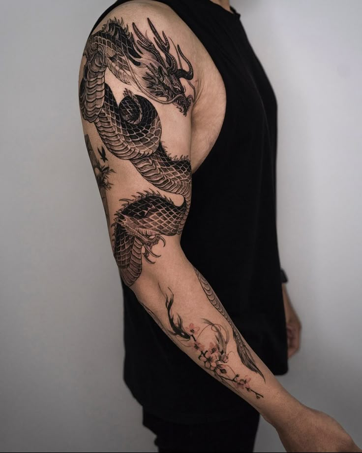 a man with a dragon tattoo on his arm