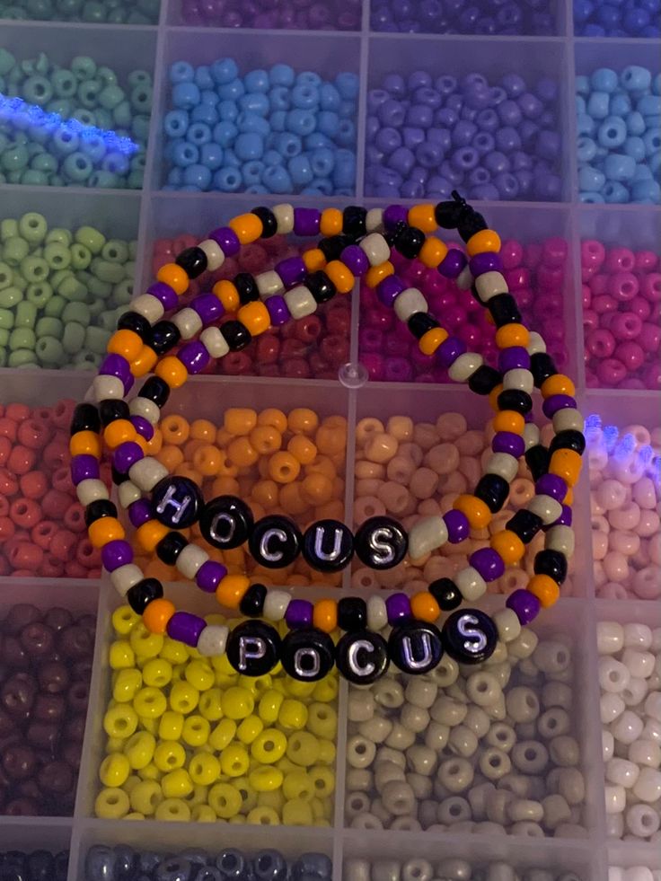 beads are arranged in different colors and shapes to spell out the word house on display