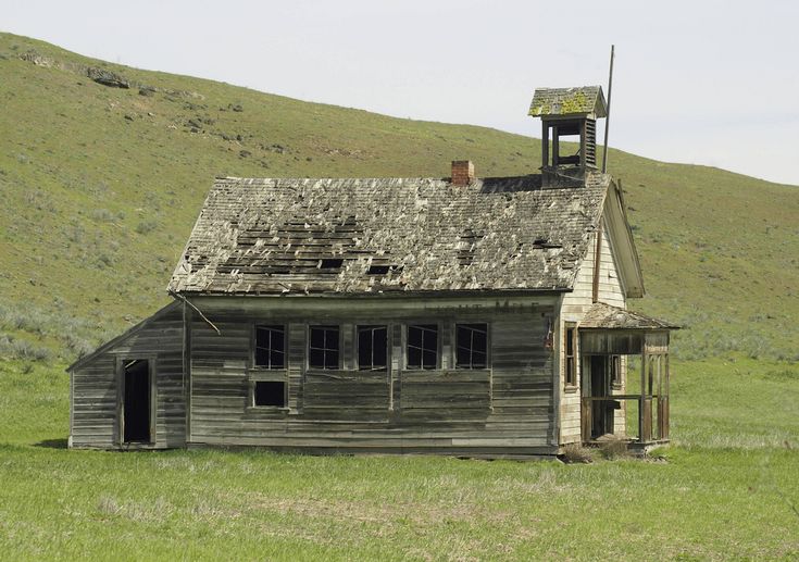 an old run down house in the middle of nowhere