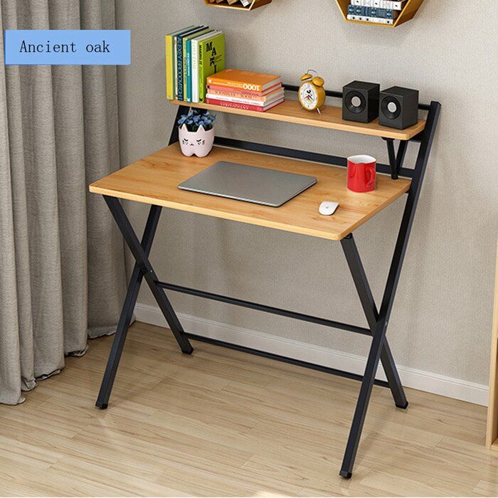 a laptop computer sitting on top of a wooden desk next to a book shelf filled with books