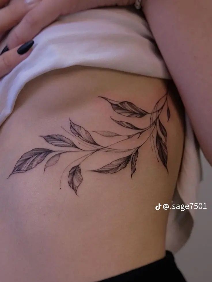 a woman with a tattoo on her stomach is holding onto the side of her thigh