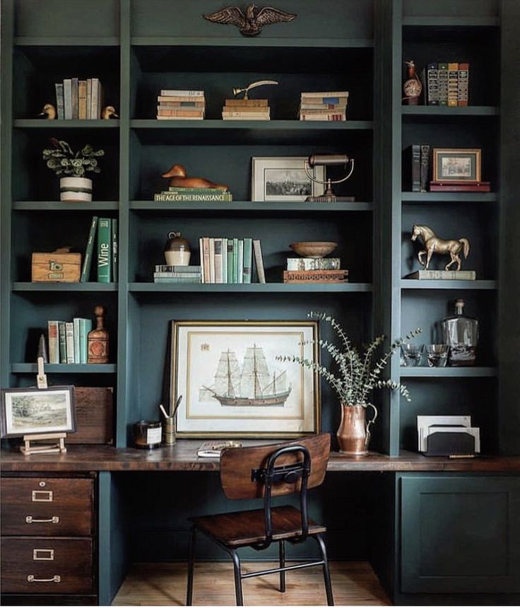 an office with bookshelves, desk and chair in front of the bookcase