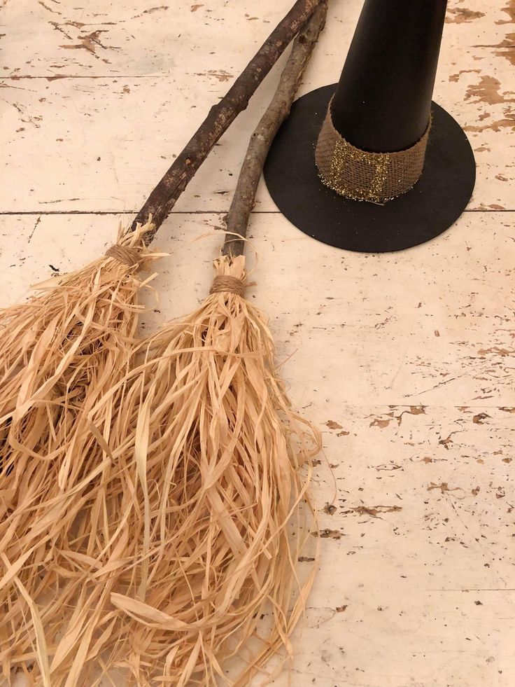 two brooms and a hat on the ground