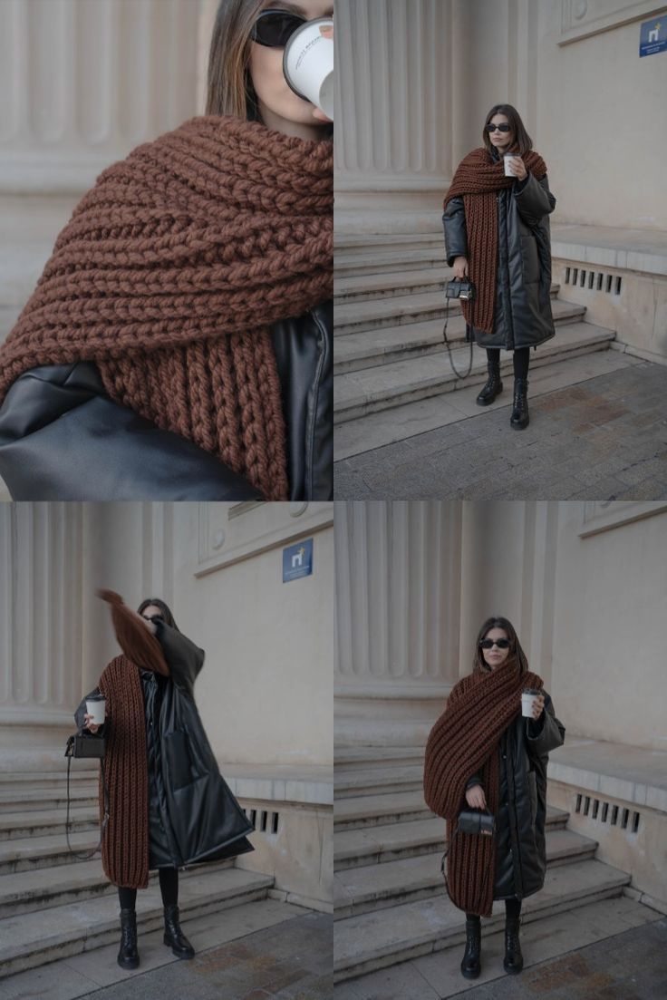 a woman wearing a scarf and holding a cup in her hand while standing on some steps