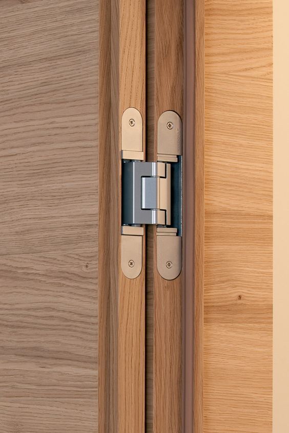 a close up of a wooden door with a hinge on the front and side