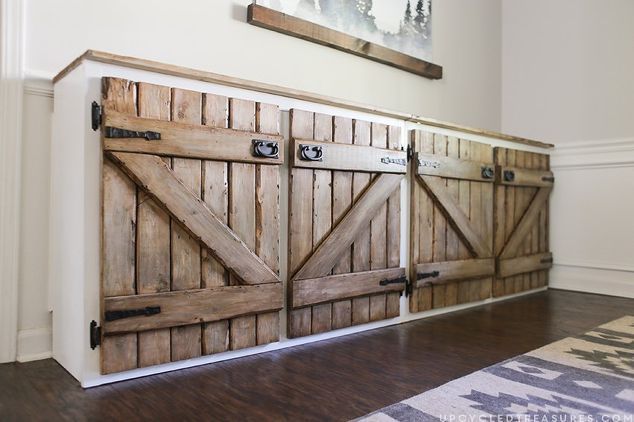 a room that has some wooden doors on the wall and hardwood floors in front of it