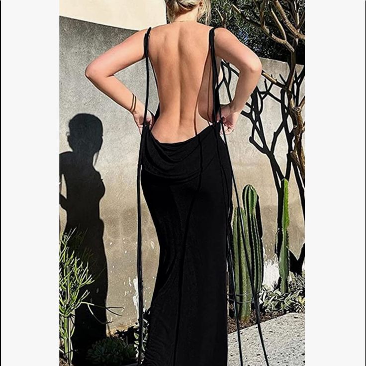 Egypt Backless Maxi Dress In Black, Crafted From Soft Fabric. If You Like To Stand Out, The Dress Is For You! This Gorgeous Piece Features Signature Back Drape. Designed To Make A Statement!! Never Worn Opted For Wearing The White Which You Can See On Pics. White Is For Sale As Well Material: 100% Polyester Stretch Factor: Slight Stretch You Can See Some Of My Outfits On Instagram @Cukycrisp Please No Offers On My Insta Page Evening Sleeveless Backless Dress With Lace-up Back, Black Low-back Maxi Dress For Evening, Black Low Back Maxi Dress For Evening, Black Backless Maxi Dress With Tie Back, Stretch Maxi Dress With Tie Back For Party, Backless Tie Back Maxi Dress For Evening, Evening Backless Maxi Dress With Tie Back, Black Low Back Maxi Dress For Night Out, Party Maxi Dress With Strappy Back Opening