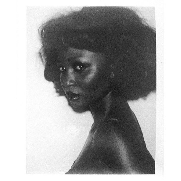 a black and white photo of a woman's face with her hair blowing in the wind