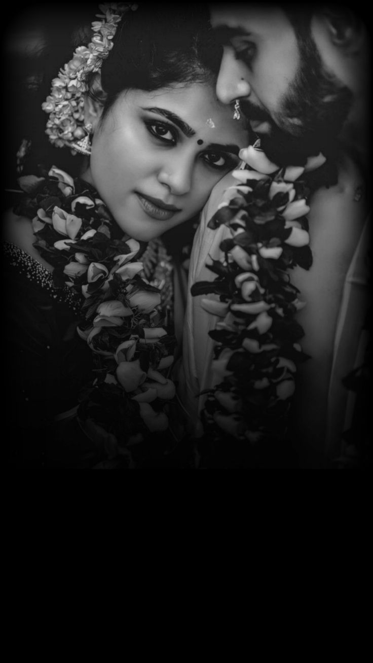 black and white photo of two women with flowers in their hair