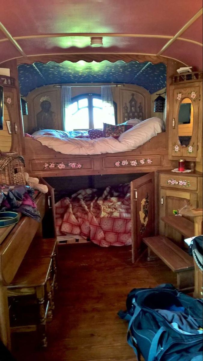 the inside of a camper with bunk beds and desks in it's center