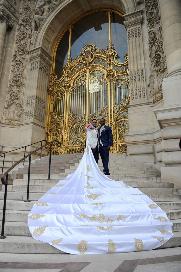 a bride and groom standing in front of an ornate building