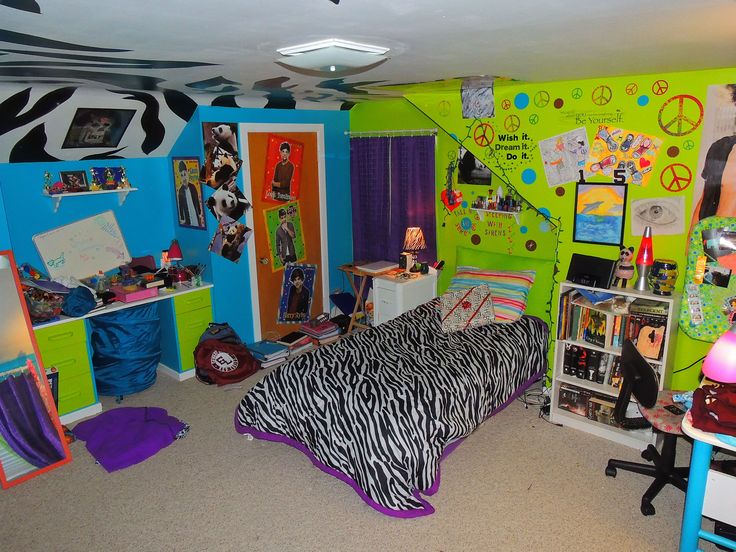 a bedroom with zebra print bedding and green walls, purple curtains, and colorful decorations