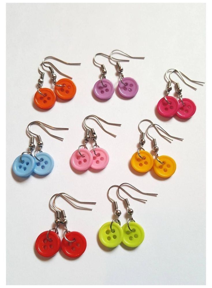 six pairs of earrings with different colored buttons