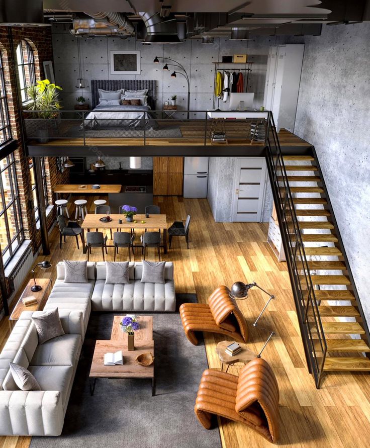 an aerial view of a living room and kitchen area with stairs leading up to the second floor