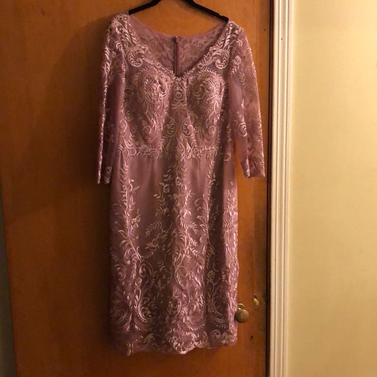 a purple dress hanging on a door