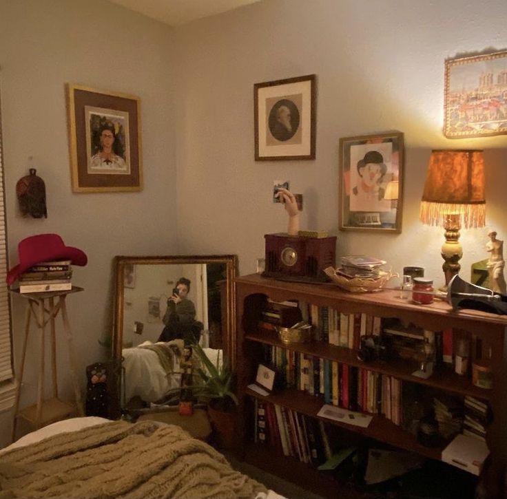 a bed room with a neatly made bed and pictures on the wall