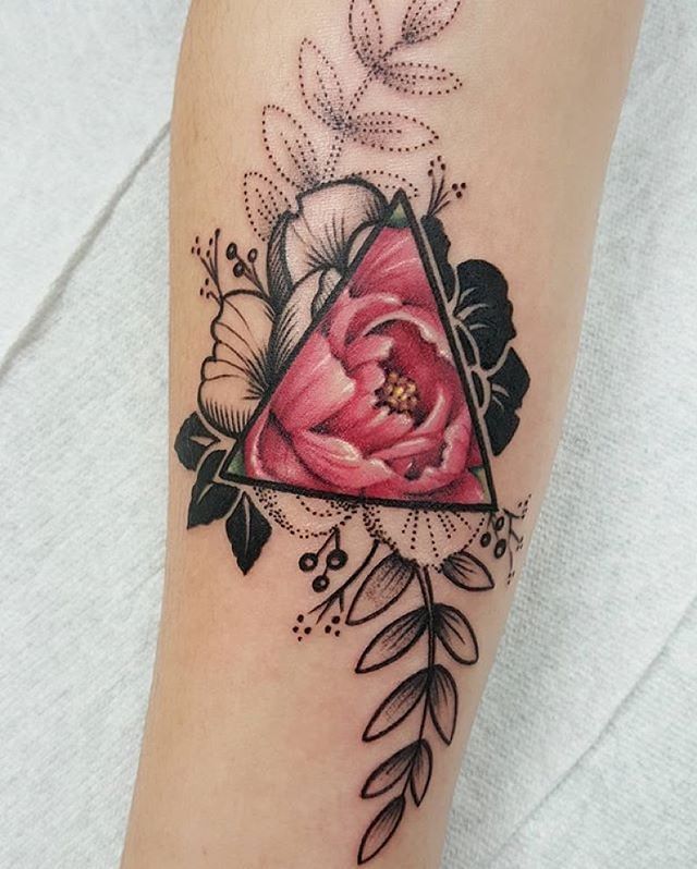 a woman's arm with a flower and triangle tattoo on the left side of her leg