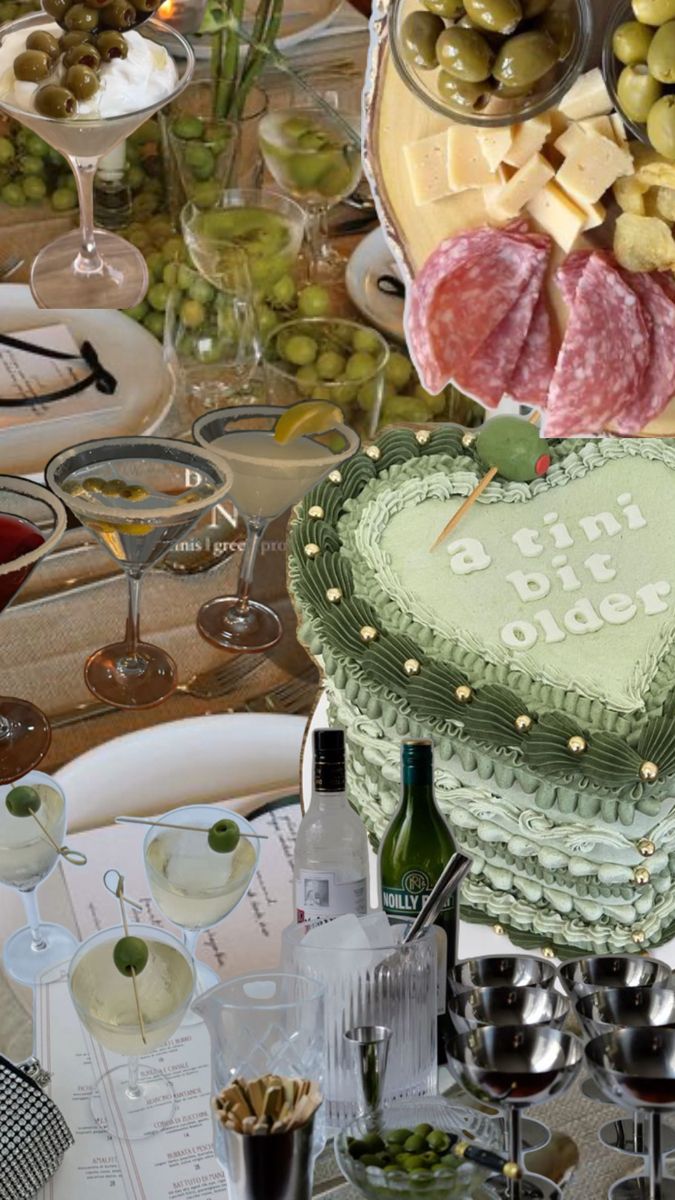 there is a heart shaped cake on the table with wine glasses and other dishes around it