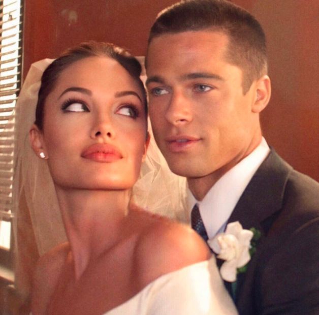 a bride and groom pose for a wedding photo