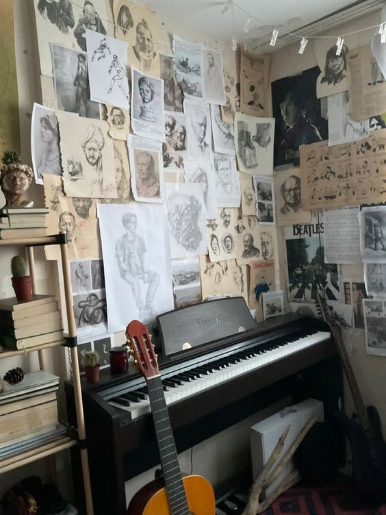 a room filled with musical instruments and lots of pictures on the wall next to it