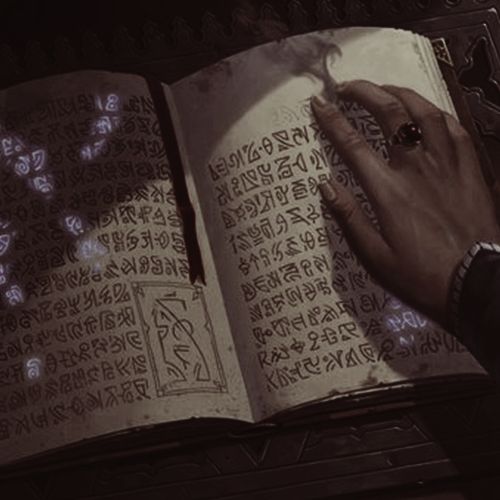 a person writing on an open book with chinese characters in the pages and symbols around it