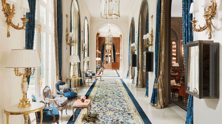 the hallway is decorated with blue and gold trimmings, along with chandeliers