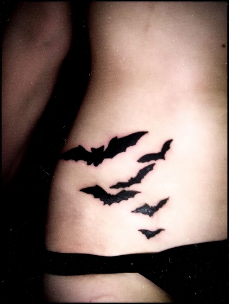 a woman's stomach with bats on it