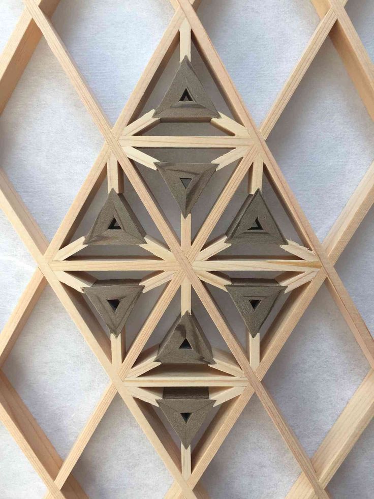 an intricate wooden design on the side of a building