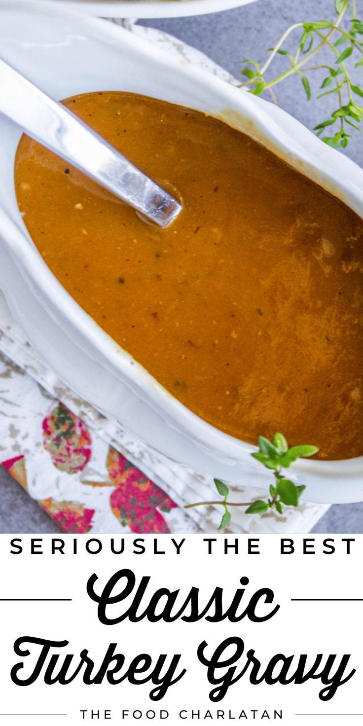 a white bowl filled with turkey gravy on top of a table