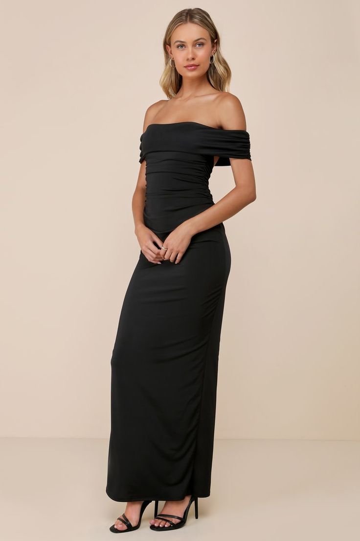 a woman wearing a black off the shoulder dress