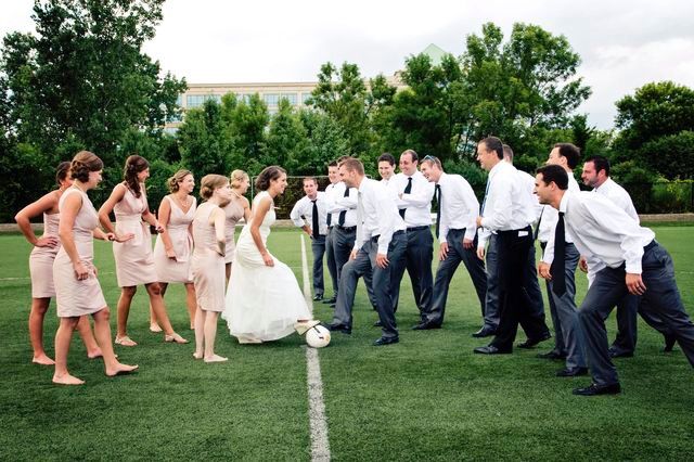 a group of people that are standing in the grass