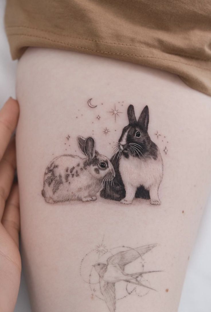 a woman's thigh with two rabbits on it