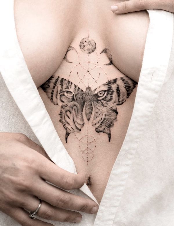 a woman's chest with a tiger tattoo on it