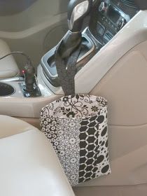 the interior of a car is decorated with black and white accessories, including a cup holder